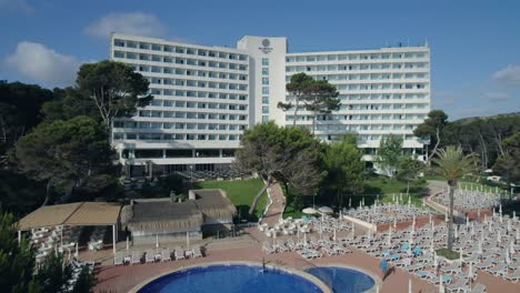 Aerial-Revealing-Hotel-Resort-and-Font-de-Sa-Cala-Beach-in-Mallorca,-Mediterranean