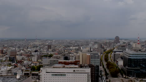 Observing-Kanazawa-city-in-Japan,-a-daytime-snapshot-of-the-expansive-cityscape-under-cloudy-skies,-symbolizes-the-essence-of-a-megapolis-and-urban-living