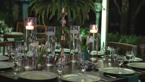 Table-decorated-with-natural-foliage-centerpieces-and-glassware-for-wedding-reception