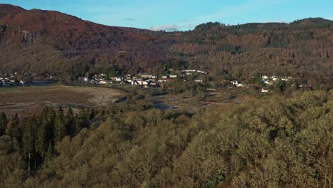 Aberfoyle-Village-with-the-River-Forth-Flowing-Peacefully-Across-the-Fall-Landscape-from-an-Aerial-Drone