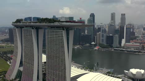 Marina-Bay-Sands-Singapore-from-an-Aerial-Panning-View-with-Skyscrapers-in-the-Background-Across-the-Harbor