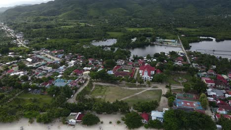 Aerial-Drone-Fly-Above-Anda-Philippines-Valley-Small-Town-around-Green-Jungle-Valley