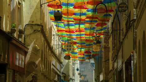 Floating-Umbrellas-in-street-of-small-town-Laon-in-France,-urban-art-installation