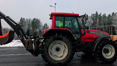 A-caravan-of-tractors-and-trucks-on-the-asphalt-road,-farmers-protest-against-government-decisions