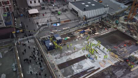 Static-bird's-eye-view-of-construction-workers-and-pedestrians-at-Slussen-in-Stockholm