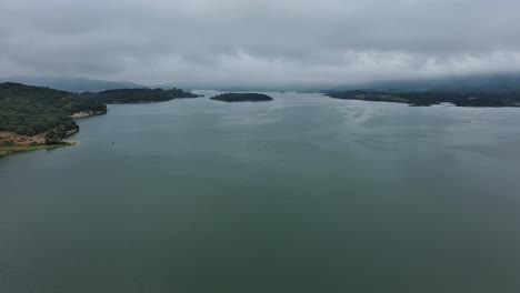 Overcast-day-aerial-view-of-Nanclares-de-Gamboa,-Basque-Country,-serene-waters