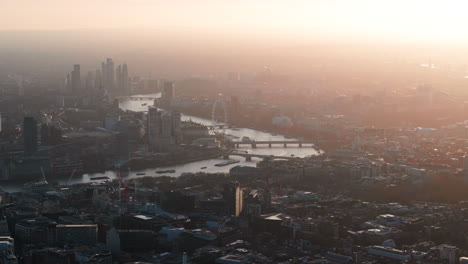 Tight-aerial-shot-looking-towards-the-London-eye-and-houses-of-parliament-on-the-Thames-at-sunset