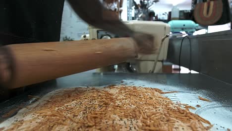 Bäcker-Rollt-Ein-Stück-Teig-Mit-Käse-Aus,-Um-Brotstangen-Zu-Machen