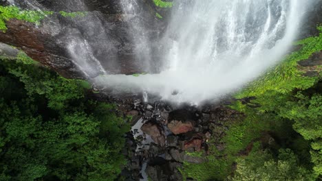 Sheets-of-water-cascade-over-a-sheer-rock-cliff-creating-a-tropical-rainforest-waterfall