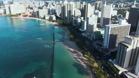 Bird's-eye-view-of-Waikiki-beach-with-high-rise-hotels-facing-ocean,-static