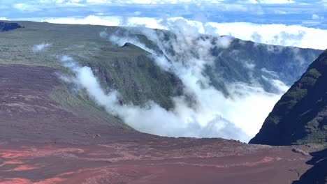 Drone-view,-fixed-on-Plaine-des-Sables-with-clouds-slowly-coming-from-Rivière-Langevin,-Réunion-Island