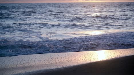 Slow-motion-footage-of-the-Pacific-Ocean-at-a-beach-at-sunset-in-San-Deigo,-California