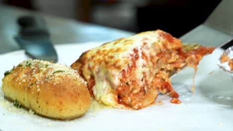 Close-up-of-Cheese-pull-from-Freshly-made-Lasagna-in-baking-tin