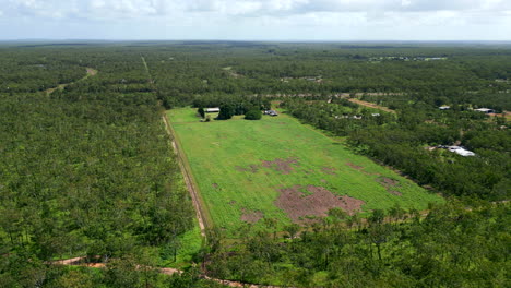 Aerial-drone-of-Rural-Outback-Acreage-Huge-Block-With-House-Set-on-Cleared-Open-Field-Between-dense-tropical-forest