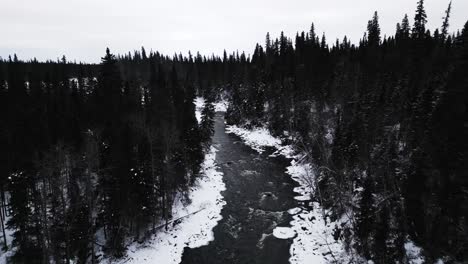 Slow-Frozen-River-4K-Drone-Shot-Landmark-frozen-winter-Water-Pisew-Kwasitchewan-Falls-Waterfall-Provincial-Park-Thompson-Manitoba-Canada