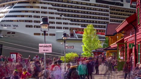 Busy-port-fjord-Flåm-big-cruise-ship-docked-touristic-Norway-village-timelapse