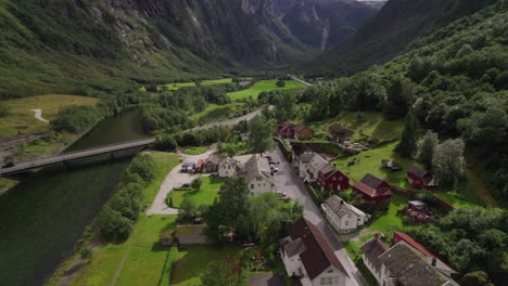 Beautiful-Village-in-Green-Valley-Surrounded-by-Mountains-in-Næroyfjord-Area-in-Norway,-Fjord-Scenery