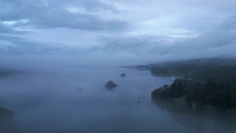 Approaching-drone-shot-of-Windermere-lake,-England's-largest-lake-located-in-in-the-county-of-Cumbria,-in-the-United-Kingdom