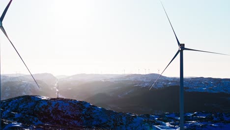 Wind-Turbines-On-Snowy-Mountains-In-Bessaker,-Norway---Drone-Shot
