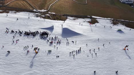 Crowd-of-people-near-winter-skiing-track-freestyle-ramp,-Dolni-Morava