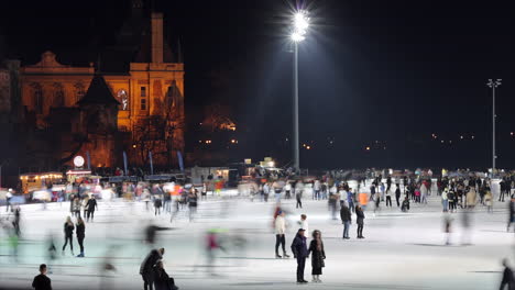 People-Skating-At-City-Park-Ice-Rink-On-Winter-Night-In-Budapest,-Hungary