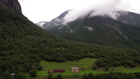 Lakeside-Touristic-Hut,-DNT-Hoemsbu-On-Eikesdalsvatnet-Lake-Shore-in-Norway-Surrounded-by-Mountains,-Aerial-View