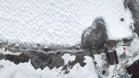 Vertikale-Antenne-Einfamilienhaus-Auf-Einem-Zugefrorenen-See-In-Der-Winterlandschaft-In-Polen