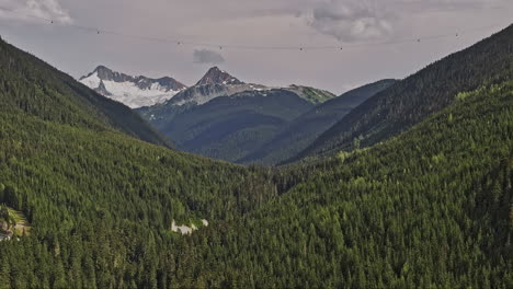Whistler-BC-Canada-Aerial-v5-zoomed-drone-flyover-capturing-breathtaking-views-of-forest-valleys-and-mountain-peaks,-with-the-gondola-crossing-the-landscape---Shot-with-Mavic-3-Pro-Cine---July-2023