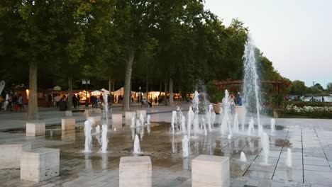 Hungary,-Balatonfüred,-Tagor-Promenade-and-wineries-through-the-fountain-in-the-city-center-during-high-season