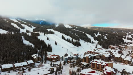 Fog-lift-cloud-layer-winter-snowy-early-morning-sunrise-aerial-drone-Copper-Mountain-Colorado-ski-resort-i70-Eagle-Flyer-lift-center-village-snowboarding-half-pipe-Ikon-Epic-pass-parking-lot-downward