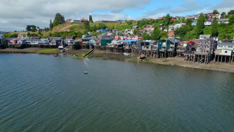 Drone-shot-circling-the-Palafitos-stilt-houses-of-Castro-city,-daytime-in-Chiloe