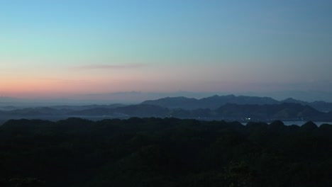 Early-dawn-breaking-over-the-serene-Philippine-mountains,-hues-of-blue-and-pink