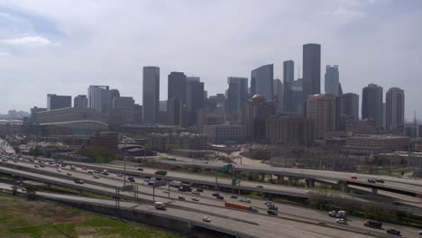 Drone-shot-of-downtown-Houston,-Texas-on-a-high-contrast-sunny-day