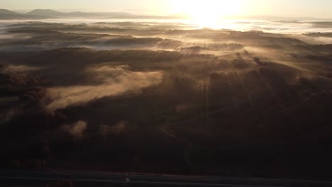 The-beauty-of-a-foggy-early-sunrise-as-beams-of-sunlight-pierce-through-the-mist