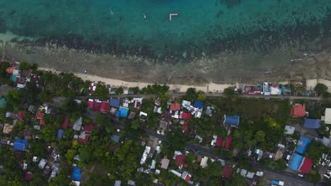 Oslob-in-cebu-island,-showcasing-vibrant-coastal-community-and-crystal-clear-waters,-aerial-view