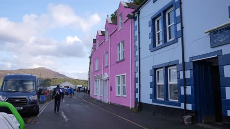 Portree,-Isle-of-Skye,-Scotland-UK,-People-on-Street-and-Waterfront-Buildings,-Slow-Motion