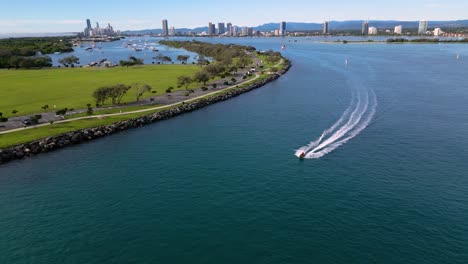 Reversing-aerial-views-over-The-Spit-following-a-jetski-on-the-Broadwater-on-the-Gold-Coast,-Australia