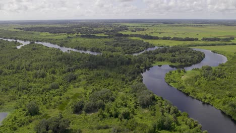 Aerial-view-of-winding-river-in-Farmland-that-connects-to-Lake-Okeechobee-in-Florida