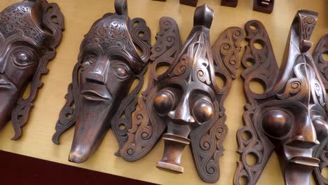Carved-traditional-Batak-masks-displayed-at-Lake-Toba,-Samosir-Island