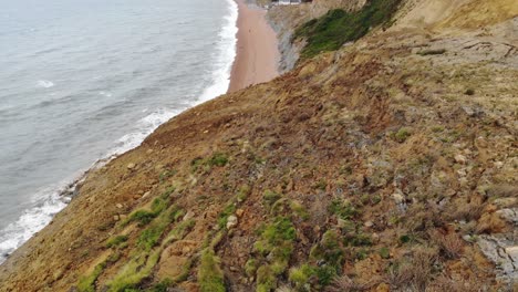 Flying-Over-Large-Coastal-landslip-With-Tilt-Up-To-Reveal-Seatown-Beach-In-Dorset