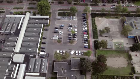 Aerial-view-of-shopping-mall-with-car-parking-lot-in-Dutch-residential-neighbourhood