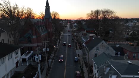 Cars-on-main-street-of-small-American-town-at-sunset-time