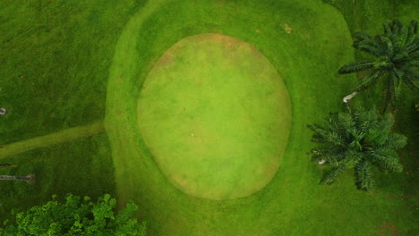 Aerial-rising-shot-above-a-putting-range-at-a-Golf-course,-in-cloudy-Cameroon