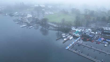 Drone-panning-from-the-right-to-the-left-side-of-the-frame,-showing-the-famous-boat-village-located-near-the-Windermere-Lake,-in-Cumbria-County,-in-United-Kingdom