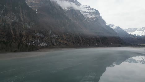 Klöntalersee-Glarus-Switzerland-flying-along-misty-mirror-lake