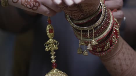 Closeup-Hands-Of-An-Indian-Bride-Wearing-Bridal-Latkan-Chuda-Bangles