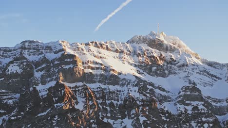 Sunrise-aerial-shot-featuring-the-silhouette-of-snow-capped-mountains