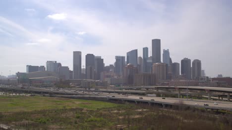 Drone-shot-of-downtown-Houston,-Texas-on-a-high-contrast-sunny-day