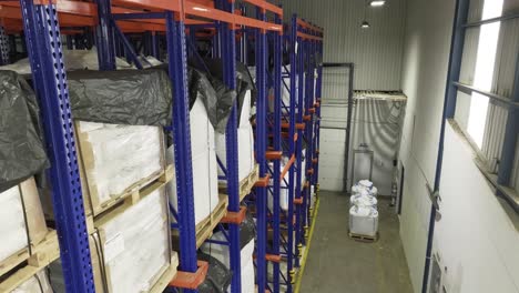 Inside-a-warehouse:-many-shelves-laden-with-neatly-stacked-pallets