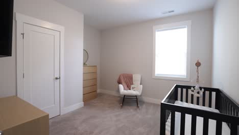 Empty-Baby's-Room-With-A-Crib-And-Cute-Carpet-On-The-Floor
